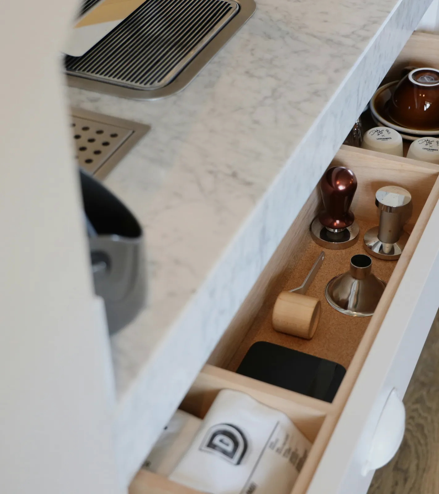 A kitchen drawer with the coffee kit neatly laid out